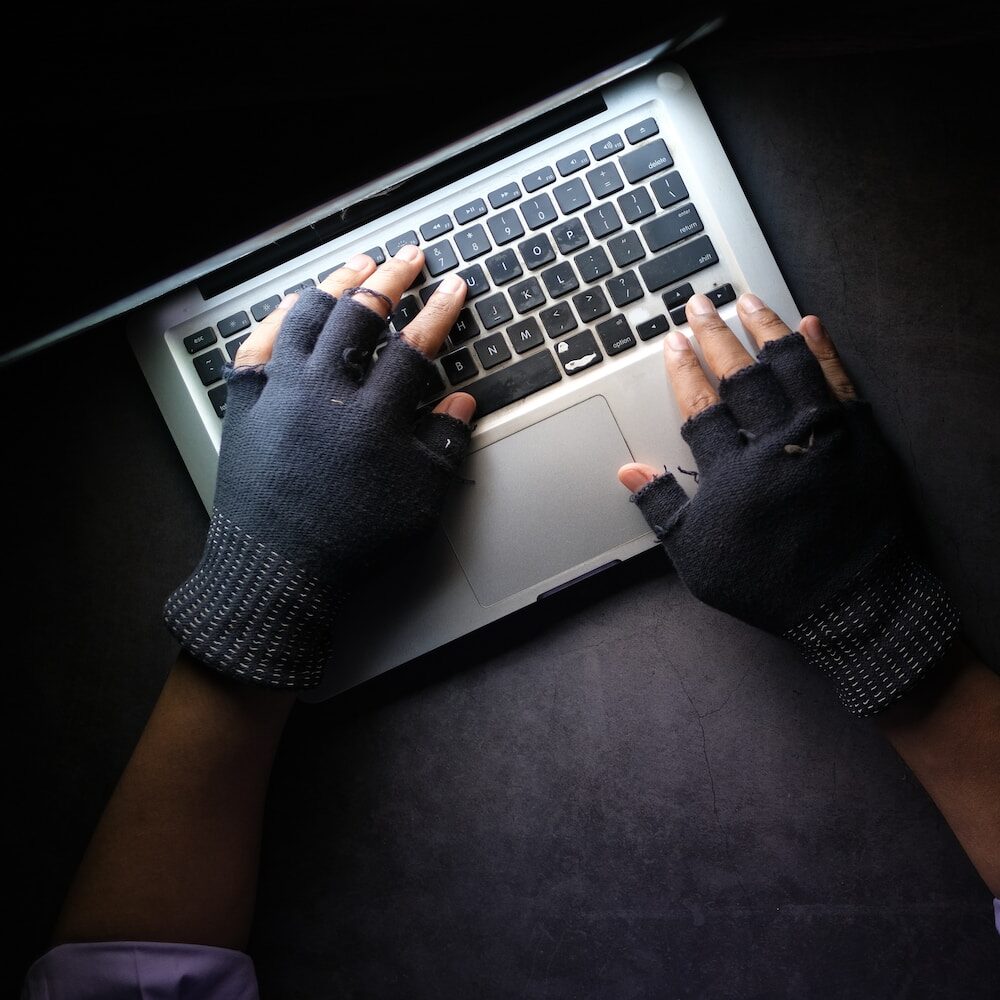 person in black long sleeve shirt using macbook pro